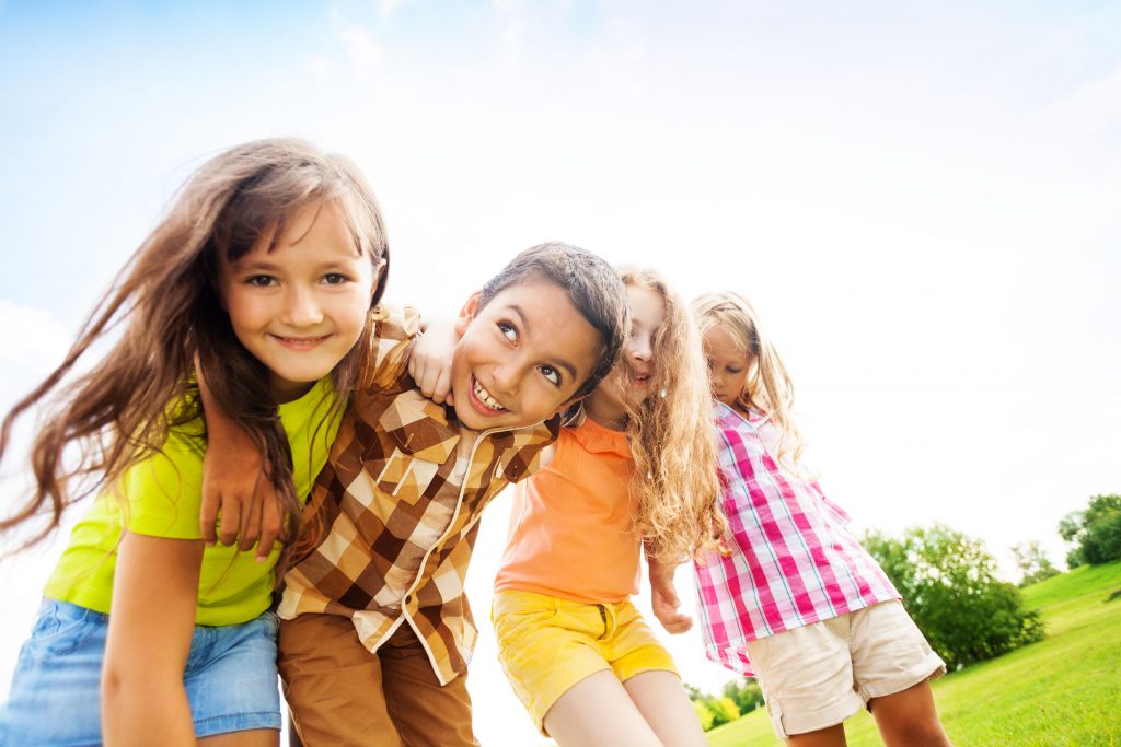 Kids smiling outside at the park