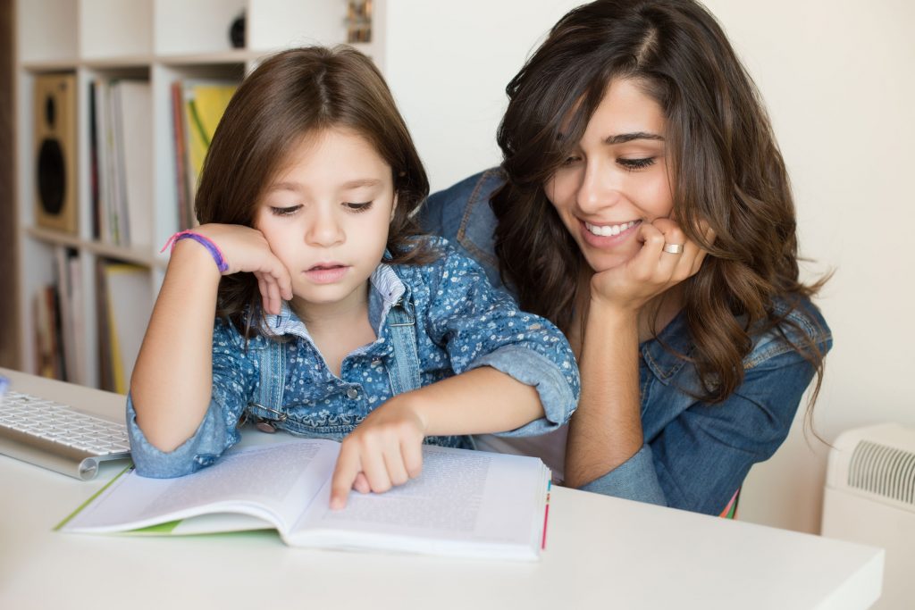 Mother helping her child with homework