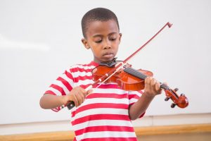music lessons benefits child docus pupil playing violin in classroom at elementary school walton academy 